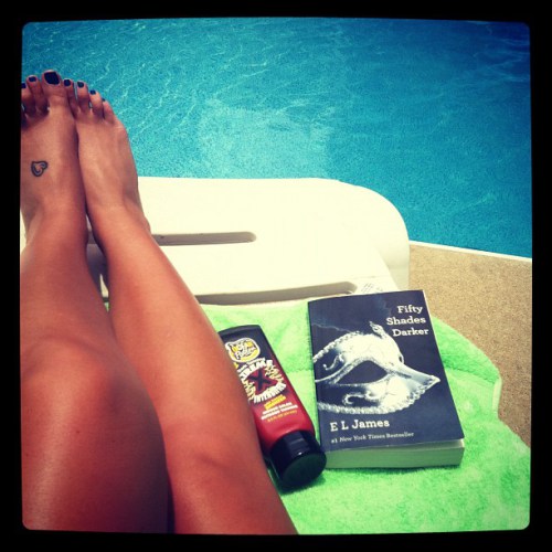 Reading Fifty Shades by the pool